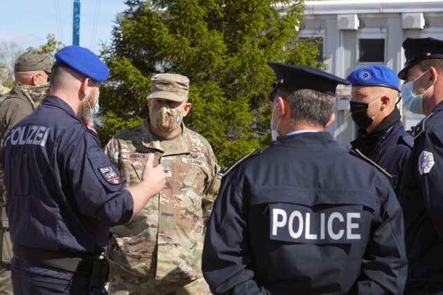 Oregon Army National Guard Col. Noel Hoback from the 41st Infantry Brigade Combat Team meets with members of the Kosovo Police and the European Union Rule of Law Mission (EULEX) Oct. 9, 2020, at a Kosovo Security Force camp near Gjakova/Dakovica, Kosovo. Hoback and the representatives from the KP and EULEX were observing a Kosovo Force training exercise. The training exercise was part of ongoing KFOR training initiatives designed to increase interoperability among nearly one dozen multinational organizations within KFOR. The training exercise was part of a progression to a larger-scale exercise held on Oct. 29.  In the event that a civil disturbance anywhere in Kosovo can no longer be controlled by local police and becomes dangerous to community members, KFOR troops may be called upon to provide assistance. All KFOR troops are responsible for ensuring a safe and secure environment for all community members in Kosovo in accordance with the United Nations Security Council Resolution 1244. (U.S. Army National Guard photo by Spc. Miguel Ruiz)