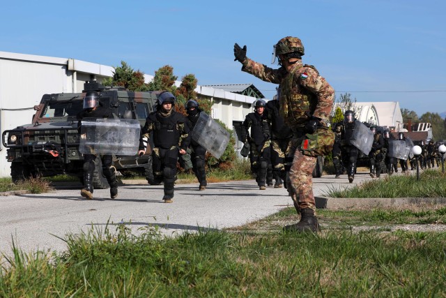 Kosovo Force troops conduct a crowd and riot control training exercise Oct. 9, 2020 at a Kosovo Security Force camp near Gjakova/Dakovica, Kosovo. Oregon Army National Guard Soldiers from the 41st Infantry Brigade Combat Team participated in the joint exercise as members of KFOR Regional-Command East. The training exercise was part of ongoing KFOR training initiatives designed to increase interoperability among nearly one dozen multinational organizations within KFOR. The training exercise was part of a progression to a larger-scale exercise held on Oct. 29. In the event that a civil disturbance anywhere in Kosovo can no longer be controlled by local police and becomes dangerous to community members, KFOR troops may be called upon to provide assistance. All KFOR troops are responsible for ensuring a safe and secure environment for all community members in Kosovo in accordance with the United Nations Security Council Resolution 1244. (U.S. Army National Guard photo by Spc. Miguel Ruiz)