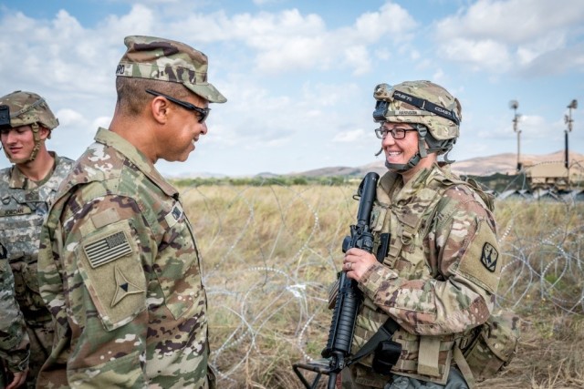 Then-Army Brig. Gen. Clement S. Coward talks with Sgt. 1st Class Tiffany N. Harrison during field training at Fort Sill, Okla., Sept. 12, 2019. Soldiers in the field are preparing for their culminating field training exercise.
