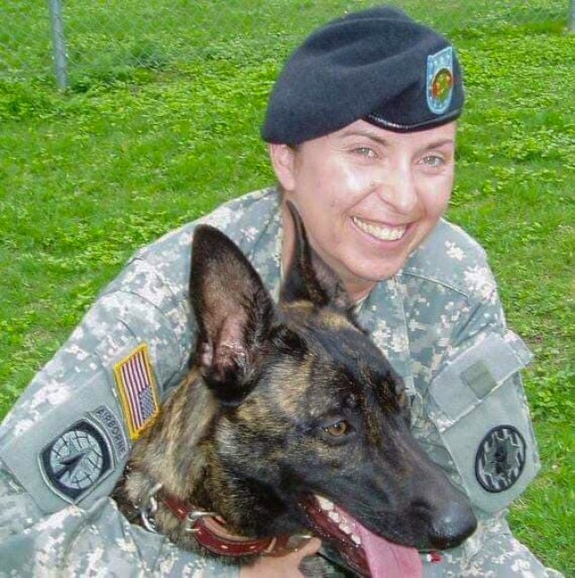 Renae Johnson trains with a military working dog named FFlint L304 in 2008. Johnson, a career handler,  attended the ceremony for a new monument titled &#34;The Pledge&#34; at the Military Women’s Memorial in Arlington, Va., Oct. 19, 2020.