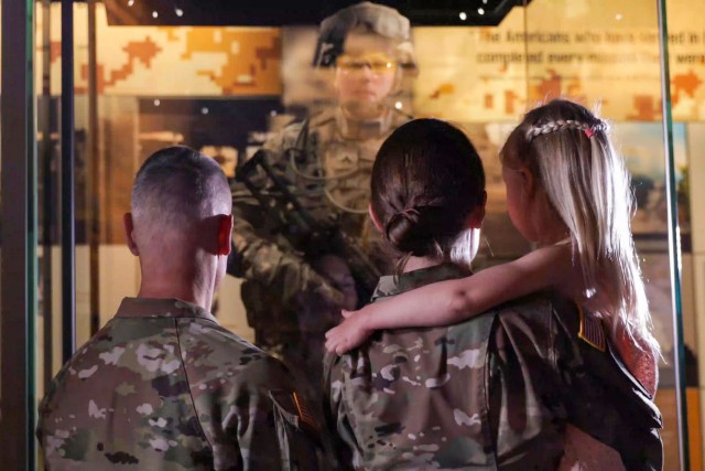 Lt. Col. Ashley Hartwell, a reservist, looks at a life-sized model in her visage on display at the National Museum of the U.S. Army, in Fort Belvoir, Va. She was joined by her husband, Maj. Kristopher Hartwell, and daughter, Grace, during the...