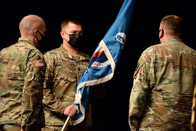 Incoming Special Troops Battalion Commander Lt. Col. Mark Winker accepts the colors from Combined Arms Center Chief of Staff Col. Thomas Bolen during Winker's change of command ceremony with outgoing STB Commander Lt. Col. Charles D. Ausman Oct....
