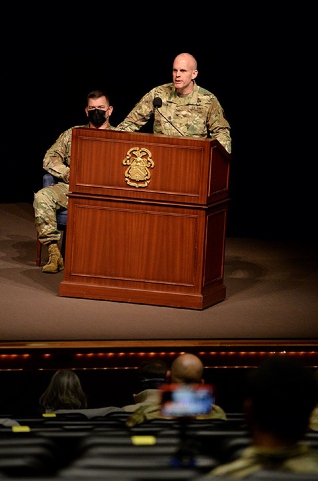 Combined Arms Center Chief of Staff Col. Thomas Bolen delivers remarks during the change of command ceremony for outgoing Special Troops Battalion Commander Lt. Col. Charles D. Ausman and incoming STB Commander Lt. Col. Mark Winker, left, as Sgt....