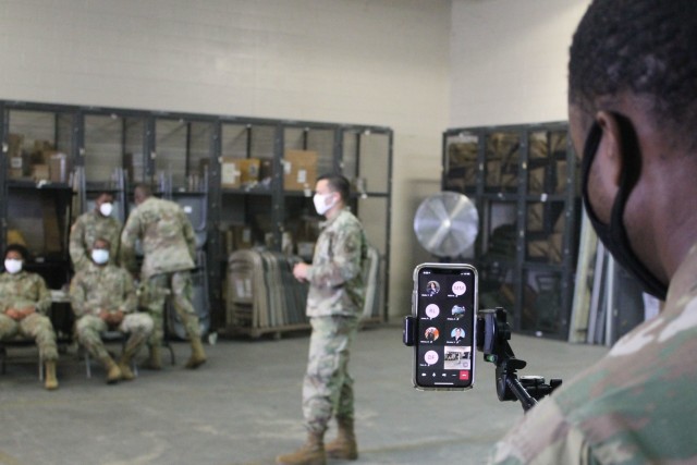 A U.S. Army Reserve Soldier monitors a cell phone during a live broadcast of primary marksmanship instruction for a battle assembly in Belle Chasse, Louisiana Oct. 25, 2020.  The 377th Theater Sustainment conducted its first hybrid battle assembly...