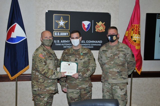 Gen. Edward Daly (left), commanding general Army Materiel Command, presents Capt. Jesse Meininger (center), with the AMC Adjutant General of the Year award as Brig. Gen. Darren Werner (right), commanding general Tank-automotive and Armaments Command looks on at the Detroit Arsenal Nov. 4.  Meininger serves as the Adjutant General for TACOM and earned the award for his professionalism and attention to detail.