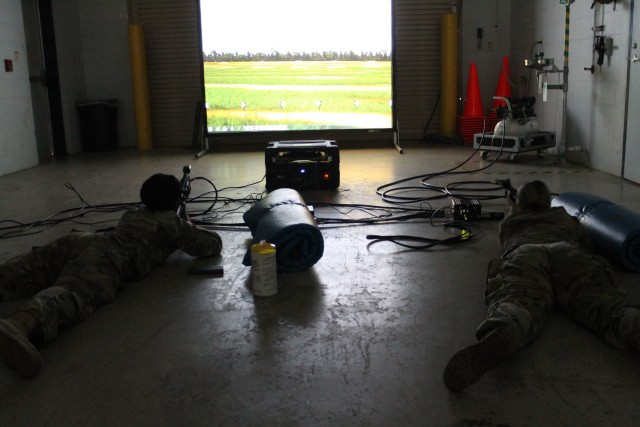 Two Soldiers take aim at targets on the Engagement Skills Trainer II during a 377th Theater Sustainment Command battle assembly in Belle Chasse, Louisiana Oct. 25, 2020.  The 377th TSC used the EST II as part of its primary marksmanship instruction for Soldiers attending battle assembly.  Others saw live demonstrations during a virtual presentation. The command is using a combination of virtual and in-person training to increase safety in a COVID environment. 