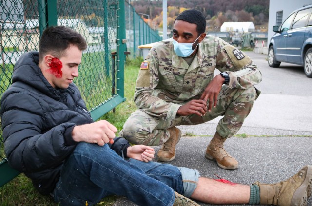 Spc. Markell Pinkett, a dental specialist with the 566th Area Support Medical Company, 61st Medical Battalion, Fort Hood, Texas, checks on a patient during a mock mass casualty vehicle collision in Hohenfels, Germany, on Nov. 4, 2020. Members of...