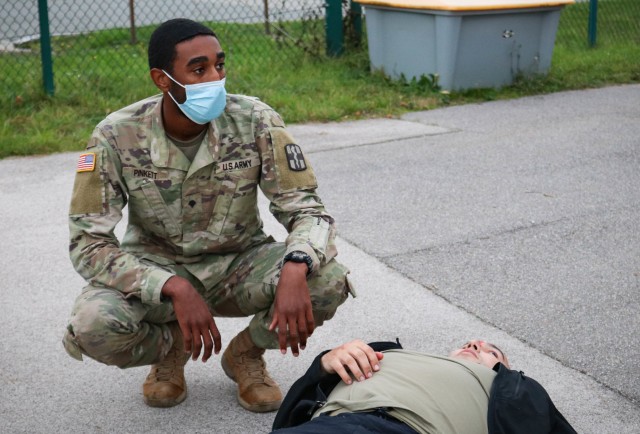 Spc. Markell Pinkett, a dental specialist with the 566th Area Support Medical Company, 61st Medical Battalion, Fort Hood, Texas, checks on a patient during a mock mass casualty vehicle collision in Hohenfels, Germany, on Nov. 4, 2020. Members of...