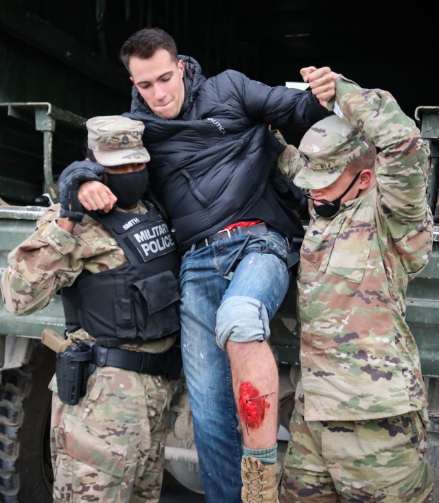 Soldiers assigned to the 29th Military Police Company, Maryland Army National Guard, and the 566th Area Support Medical Company, 61st Medical Battalion, carry a mock patient to a secure location during a mass casualty training event at the Joint...