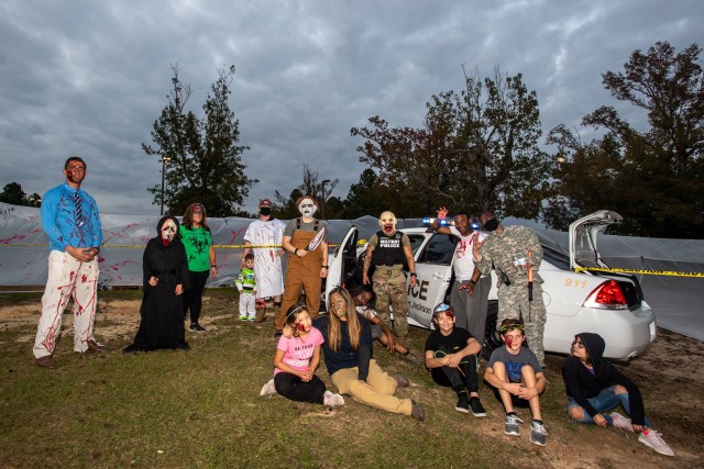 Soldiers from Headquarters, Headquarters Battalion pose for a photo during the Haunted Trail put on for families on Oct. 28.