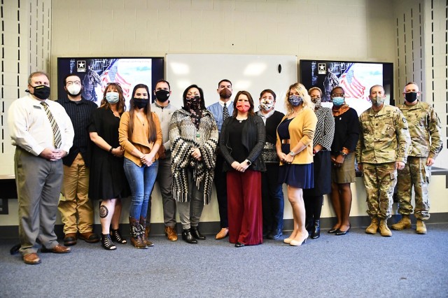Forging New Leaders course graduates stand with Bobbie Parks (left), workforce development officer, Col. Ryan K. Roseberry (right), Fort Polk garrison commander, and Command Sgt. Maj. Christopher Ausbun (second to the right), Fort Polk garrison...
