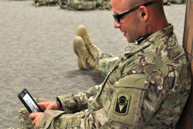 A Soldier uses the Military OneSource app on his cellphone.