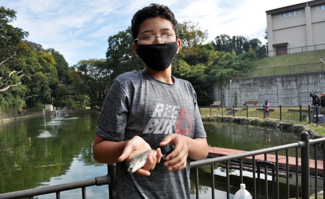 Amory Williams, 13, shows off the trout he caught 1 minute, 46 seconds into the Community Trout Fishing Derby at Camp Zama, Japan, Nov. 7. The fish won Amory an award for first fish caught during the derby. He caught a total of five and also won...