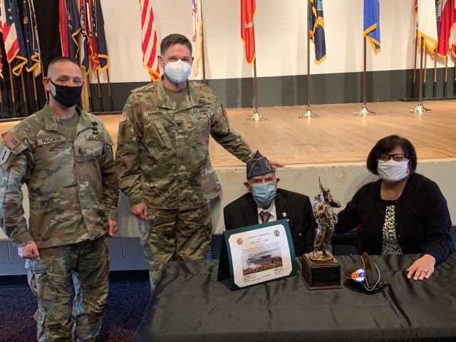 Col. Martin, Fort Hamilton Garrison Commander, presents guest of honor, Dino Lamia, with a token of appreciation during the Veterans Day Ceremony at the post theater on Fort Hamilton, N.Y., Nov 6. 2020. Lamia, a Bay Ridge, N.Y. native, also served...