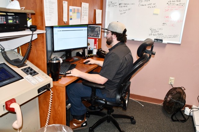 Joseph Wells, airfield management specialist, works at his desk Oct. 28.