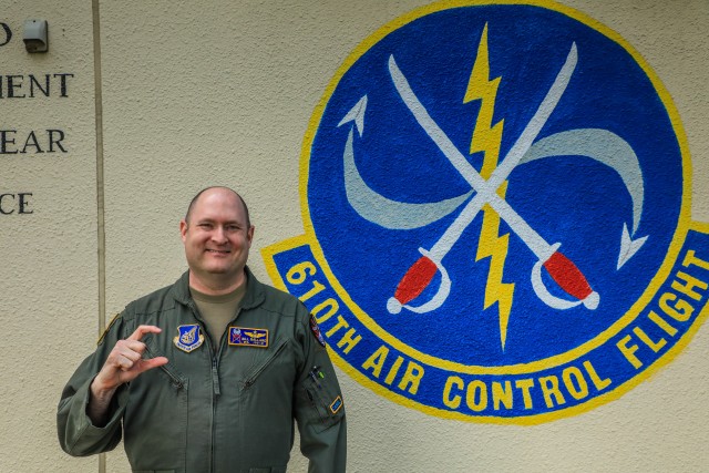 U.S. Air Force Lt. Col. William H. Ballard, 610th Air Control Flight commander, poses with a "C" hand signal for camel, to hail their unit heritage and tradition. The hand sign represents constantly working to perfect the unit's craft of tactical command and control, while advocating for the capabilities they bring to the fight, standing their ground when required, and providing a constant, reliable teammate for fighter pilots and teammates as embodied by Col. Lawson P. Wynne and the other Camel Controllers that came before them. The 610th ACF participated in Keen Sword 21 at Misawa Air Base to successfully facilitate all the Air Force mission sets and enable kinetics to be able to employ weapon systems against the enemy while coming together and actively integrating U.S.-Japan air defense, maritime, and land assets in the defense of the United States and Japan.