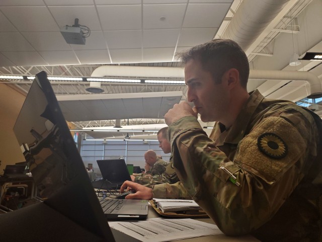 1st Sgt. Mark Hanson, first sergeant of the 105th Mobile Public Affairs Detachment, utilizes the an automated records system to help evaluate Soldiers on qualities that show the most potential for promotion during a Kansas Army National Guard...