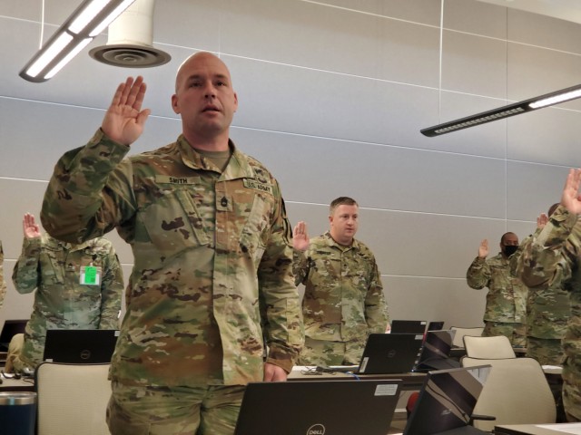Sgt. 1st Class Justin Smith, marketing noncommissioned officer for the Kansas Army National Guard Recruiting and Retention Battalion, swears an oath of confidentiality to protect the information of Soldiers prior to evaluating them for promotions...