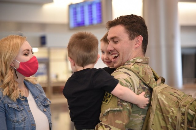 A Soldier greets his Family at Salt Lake City International Airport, Oct. 6, 2020, after returning home from his deployment. 