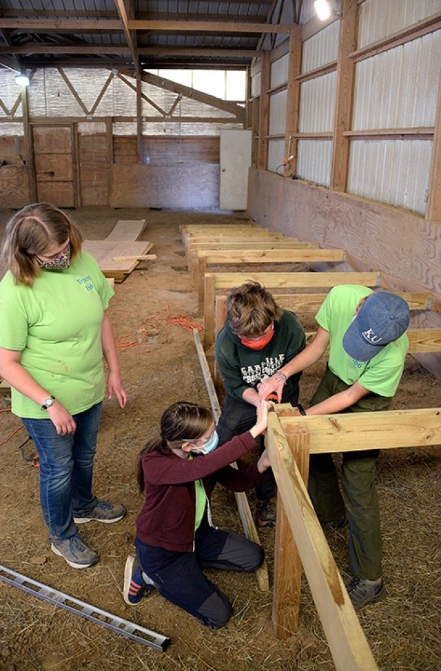 Emily Harris, member of Scouts BSA Troop 166, oversees the work of her Eagle Scout project volunteers — including 12-year-old Katharina Ruthe, Troop 166; 15-year-old Kathleen O'Sullivan, Lansing (Kan.) Venture Crew 2165; and her sister,...