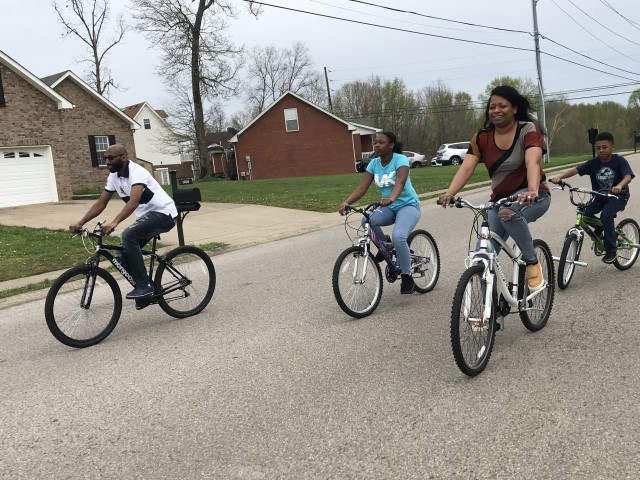 David Allen, left, and his wife Wanda, right, ride bicycles with their children Caniyah Hampton, 12 and L. J. Hampton, 8, in their neighborhood. Fort Campbell Ready and Resilient Program performance experts encourage everyone to remain connected...