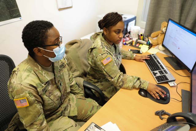 MIHAIL KOGALNICEANU, ROMANIA -- Staff Sgt. Breanna Gray, Non-Commissioned Officer in Charge, Troop Medical Clinic, and one of her Soldiers, Spc. Laneeja Sheppard, Senior Medic, MK Aid Station, review a daily task report to plan for what needs to...