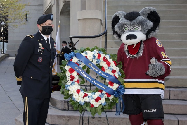 Brig. Gen. Ernest Litynski, left, Commanding General, 85th U.S. Army Reserve Support Command, pauses for a photo with “Skates”, mascot for the Chicago Wolves, during a Veteran’s Day commemoration, hosted by the Chicago Wolves, at the Vietnam Memorial Wall at Chicago’s Riverwalk, Nov. 11, 2020. The ceremony was coordinated between the Chicago Wolves and several local military organizations to hold COVID-19 mitigation efforts as a key priority while honoring Chicago’s and the nation’s veterans.
(U.S. Army Reserve photo by Anthony L. Taylor)
