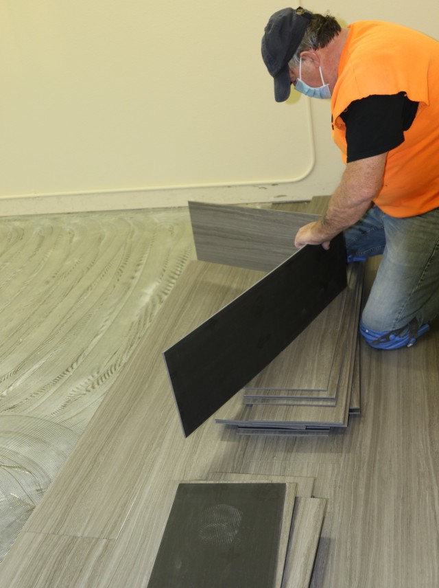 Ed Nicholas, a Job Order Contractor with Fort Greely’s Department of Public Works, prepares plank flooring as part of a larger quality-of-life campaign on Fort Greely Nov. 4. Upgrades to the Fort Greely single soldier barracks is scheduled to be completed by early 2021. (Photo by U.S. Army Garrison Alaska, Fort Greely Public Affairs Intern, Sophia Glushko)