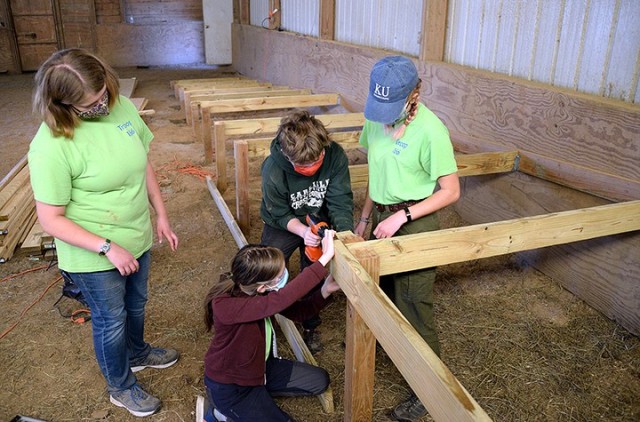 Emily Harris, member of Scouts BSA Troop 166, oversees the work of her Eagle Scout project volunteers — including 12-year-old Katharina Ruthe, Troop 166; 15-year-old Kathleen O'Sullivan, Lansing (Kan.) Venture Crew 2165; and her sister,...
