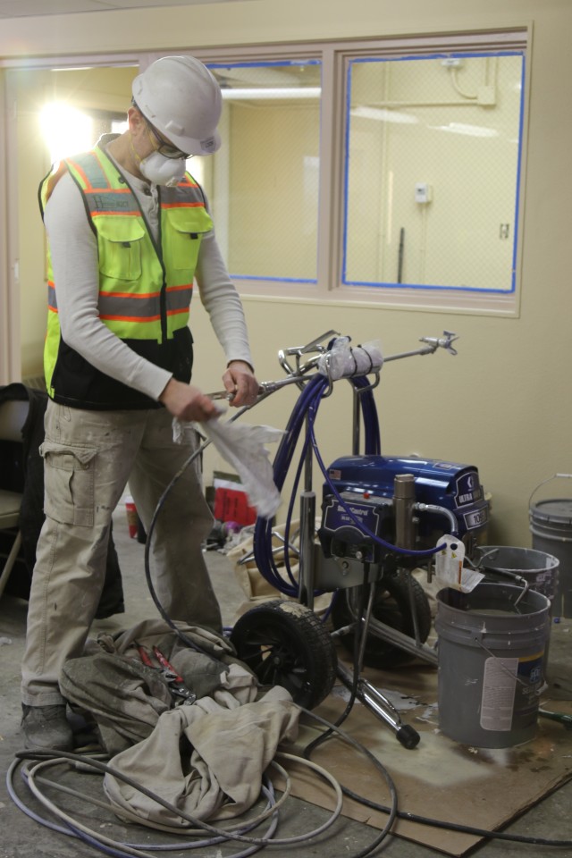 Paul Novikov, lead painter and Job Order Contractor with Fort Greely’s Department of Public Works, prepares painting equipment during renovation of the single soldier barracks on Fort Greely Nov. 4. “It’s been a challenge on the first level,” said Novikov. “But I think we can deliver this living area for the troops on schedule.” The Fort Greely single soldier barracks, currently under construction as part of a larger quality-of-life campaign, is scheduled to be completed by early 2021. (Photo by U.S. Army Garrison Alaska, Fort Greely Public Affairs Intern, Sophia Glushko)