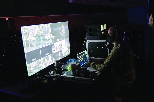 Staff Sgt. Joshua Buxton, concert production noncommissioned officer in charge, directs the recording angles and effects of six fellow band members on video recording equipment throughout the hall. Buxton, who originally joined the band as a...