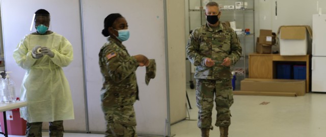 MIHAIL KOGALNICEANU, ROMANIA -- Staff Sgt. Breanna Gray, Non-Commissioned Officer in Charge, Troop Medical Clinic, addresses Soldiers as they make adjustments to the COVID screening they were conducting on Nov. 6. Her boss, Col. Jeffrey A. Wade,...