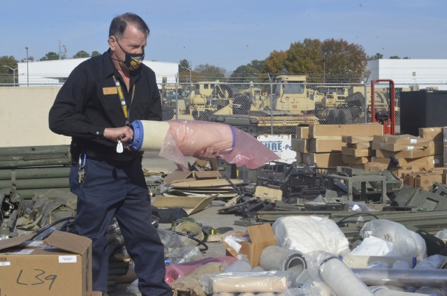 Fort Campbell Qualified Recycling Program Manager Rob Anderson examines a filter from a loose bag to see if it is still good or needs to be disposed of Nov. 5 as part of Operation Clean Eagle, , the 101st Airborne Division’s postwide cleanup...