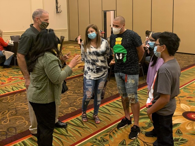 U.S. Army South Commanding General Maj. Gen. Daniel R. Walrath and his wife (left) encourage family members in attendance at the Strong Bonds couples training Nov. 7 at the Hyatt Regency Hill Country Resort in San Antonio, Texas. Strong Bonds is a...