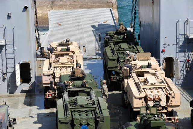 U.S. Army and U.S. Marine M142 High Mobility Artillery Rocket Systems prepare to disembark Logistics Support Vessel-4 Lt. Gen. William B. Bunker, 8th Theater Sustainment Command, to execute live rapid equipment deployment training at Kin Red Beach Training Area Oct. 31. Orient Shield 21-1 is the largest U.S. Army field training exercise in Japan that tests and refines multi-domain operations. (U.S. Army photo by Maj. Elias M. Chelala)