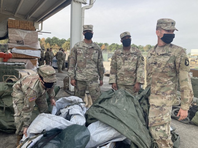 Specialist Daniella Valverde, left, Pfc. Jawun Perry, Sgt. Vincent Thomas and Spec. Jon Adrian, all of 526th Brigade Support Battalion, 2nd Brigade Combat Team, 101st Airborne Division (Air Assault) fold tarps as they go through storage items Nov....