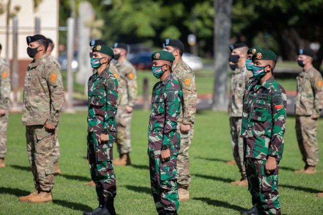 Soldiers assigned to 3rd Squadron, 4th Cavalry Regiment, 3rd Infantry Brigade Combat Team, 25th Infantry Division stand together in formation with Soldiers assigned to the Indonesian Army's 431st Para Raider Infantry Battalion during the opening ceremony of the U.S. hosted portion of the 2020 Indonesia Platoon Exchange at Schofield Barracks, Hawaii on Nov. 14, 2020. Throughout the next two weeks, Soldier from both armies will train alongside one another sharing their expertise in tactics to include counter-improvised explosive device training, Military Operations in Urban Terrain (MOUT) training and survival training at the 25th Infantry Division's Lightning Academy. (U.S. Army photo by Staff Sgt. Alan Brutus)