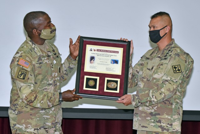 Lt. Col. (P) Johnny Paul, Department Chair, Combat Medic Specialist Training Program (right), accepts the Third Quarter Fiscal Year 2020 Army Medicine Wolf Pack Award from Lt. Gen. R. Scott Dingle, Surgeon General of the U.S. Army and Commanding General, U.S. Army Medical Command.