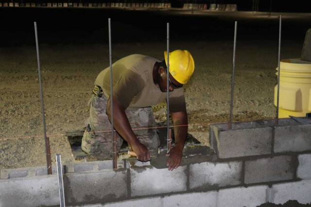 A member of the 310th Engineering Detachment works on construction a Joint Air Ground Station building in Qatar. The building is being built using troop labor from a design from the U.S. Army Corps of Engineers Middle East District's Center of...