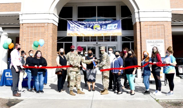 Command Sgt. Maj. Michael C. Henry, post command sergeant major (left), Tonette Macon, Fort Polk commissary officer (center) and Command Sgt. Maj. Christopher M. Ausbun, garrison command sergent major (right) hold a large pair scissors as they cut...