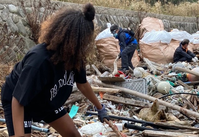 A Soldier from the 14th Missile Defense Battery at the Kyogamisaki Communication Site at Kyotango-Shi, Japan, picks up trash as part of a community cleanup of Suisho-hama Beach, Nov 8. The battery, operated by the U.S. Army Space and Missile...