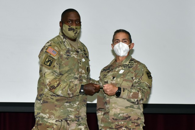 Lt. Gen. R. Scott Dingle, Surgeon General of the U.S. Army and Commanding General, U.S. Army Medical Command, presents Lt. Col.  Manuel Menendez, Commander, 232nd Medical Battalion, with a Commander’s coin.
