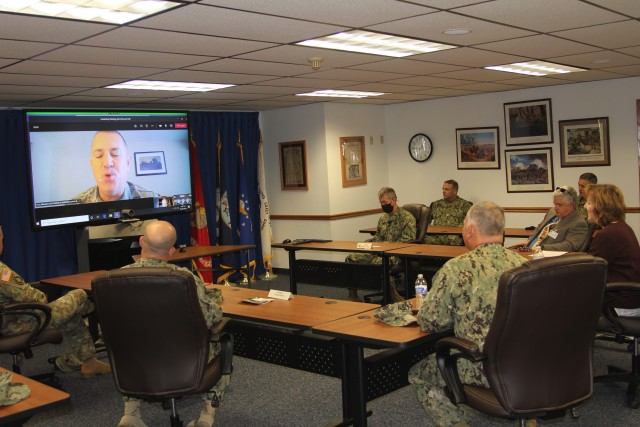 Assistant Secretary of the Navy (Manpower and Reserve Affairs) Catherine Kessmeier and Vice Adm. John Nowell, Jr., Chief of Naval Personnel (CNP), participate in a socially distanced meeting with Fort McCoy Deputy to the Garrison Commander Brad Stewart and Command Sgt. Maj. Paul Mantha, garrison command sergeant major, on Oct. 27, 2020, at the garrison headquarters building at Fort McCoy, Wis. Garrison Commander Col. Michael D. Poss dialed in virtually from a temporary duty location. The Navy leadership team visited Fort McCoy to meet with Navy cadre personnel who are working with new recruits at Fort McCoy before they attend boot camp at Recruit Training Command in Great Lakes, Ill. They stopped by to thank Fort McCoy staff for their continued support of this unique and critical Navy mission. Joining the assistant secretary and the CNP were Rear Adm. Peter Garvin, Commander of Naval Education and Training Command, Rear Adm. Jamie Sands, commander of Naval Service Training Command, and Master Chief Petty Officer of the Navy Russell Smith. (U.S. Army Photo by Kaleen Holliday, Public Affairs Office, Fort McCoy, Wis.)