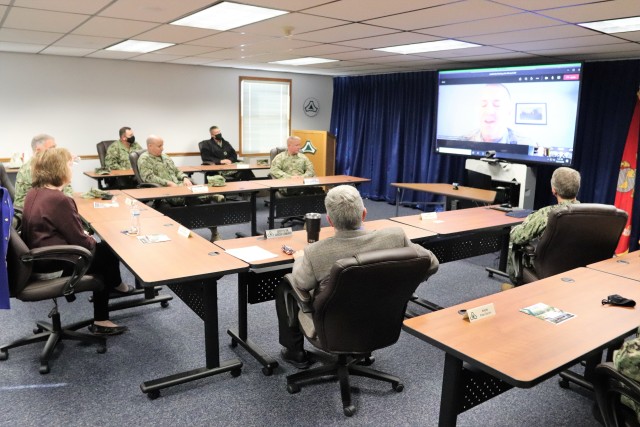 Assistant Secretary of the Navy (Manpower and Reserve Affairs) Catherine Kessmeier and Vice Adm. John Nowell, Jr., Chief of Naval Personnel (CNP), participate in a socially distanced meeting with Fort McCoy Deputy to the Garrison Commander Brad Stewart and Command Sgt. Maj. Paul Mantha, garrison command sergeant major, on Oct. 27, 2020, at the garrison headquarters building at Fort McCoy, Wis. Garrison Commander Col. Michael D. Poss dialed in virtually from a temporary duty location. The Navy leadership team visited Fort McCoy to meet with Navy cadre personnel who are working with new recruits at Fort McCoy before they attend boot camp at Recruit Training Command in Great Lakes, Ill. They stopped by to thank Fort McCoy staff for their continued support of this unique and critical Navy mission. Joining the assistant secretary and the CNP were Rear Adm. Peter Garvin, Commander of Naval Education and Training Command, Rear Adm. Jamie Sands, commander of Naval Service Training Command, and Master Chief Petty Officer of the Navy Russell Smith. (U.S. Army Photo by Scott T. Sturkol, Public Affairs Office, Fort McCoy, Wis.)