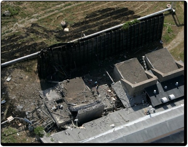 In this photo, a building was destroyed in an accident.  Because of explosive site planning, buildings around accident remained intact.