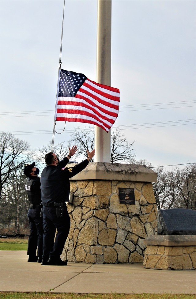 Officers with the Fort McCoy Directorate of Emergency Services Police Department raise the U.S. flag and the POW/MIA flag Nov. 12, 2020, at Fort McCoy, Wis. The team of officers replaced an older POW/MIA flag with a new one. The police regularly...