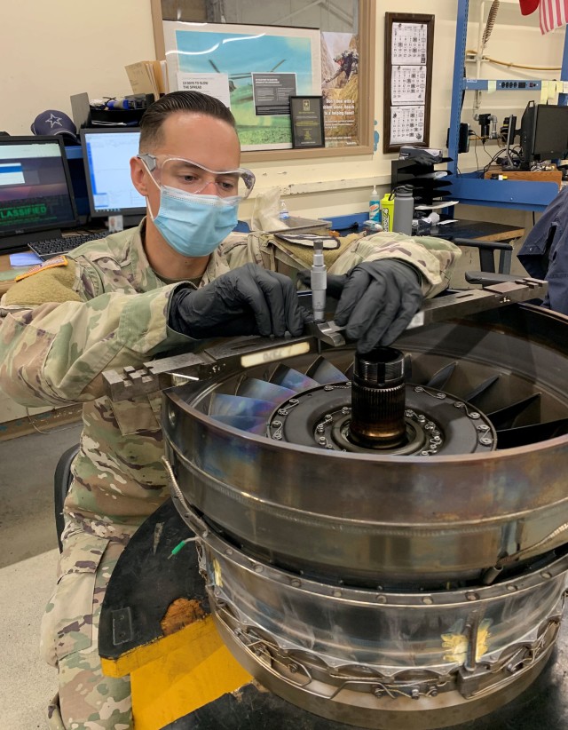 Specialist Matthew Smalley carefully calibrates engine components using specialized tool kits for the intricate assembly. He is part of the of the 1st Air Cavalry Brigade, Fort Hood, TX,  receiving Depot Level training at the Corpus Christi Army Depot (CCAD).