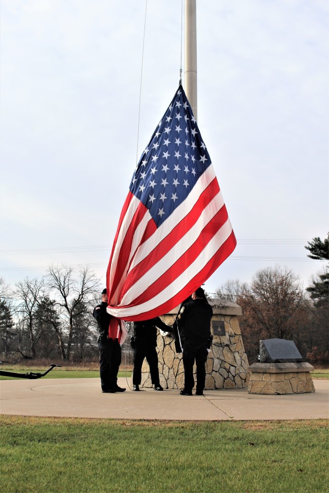Officers with the Fort McCoy Directorate of Emergency Services Police Department raise the U.S. flag and the POW/MIA flag Nov. 12, 2020, at Fort McCoy, Wis. The team of officers replaced an older POW/MIA flag with a new one. The police regularly...