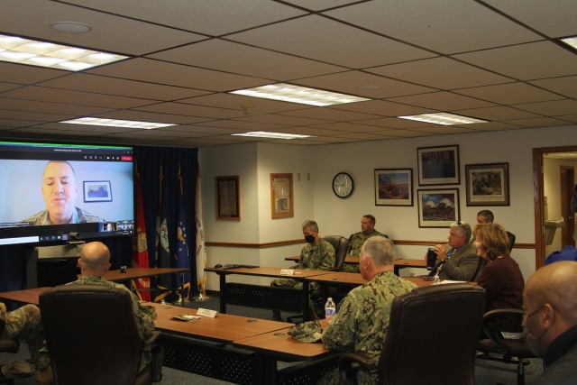 Assistant Secretary of the Navy (Manpower and Reserve Affairs) Catherine Kessmeier and Vice Adm. John Nowell, Jr., Chief of Naval Personnel (CNP), participate in a socially distanced meeting with Fort McCoy Deputy to the Garrison Commander Brad Stewart and Command Sgt. Maj. Paul Mantha, garrison command sergeant major, on Oct. 27, 2020, at the garrison headquarters building at Fort McCoy, Wis. Garrison Commander Col. Michael D. Poss dialed in virtually from a temporary duty location. The Navy leadership team visited Fort McCoy to meet with Navy cadre personnel who are working with new recruits at Fort McCoy before they attend boot camp at Recruit Training Command in Great Lakes, Ill. They stopped by to thank Fort McCoy staff for their continued support of this unique and critical Navy mission. Joining the assistant secretary and the CNP were Rear Adm. Peter Garvin, Commander of Naval Education and Training Command, Rear Adm. Jamie Sands, commander of Naval Service Training Command, and Master Chief Petty Officer of the Navy Russell Smith. (U.S. Army Photo by Kaleen Holliday, Public Affairs Office, Fort McCoy, Wis.)