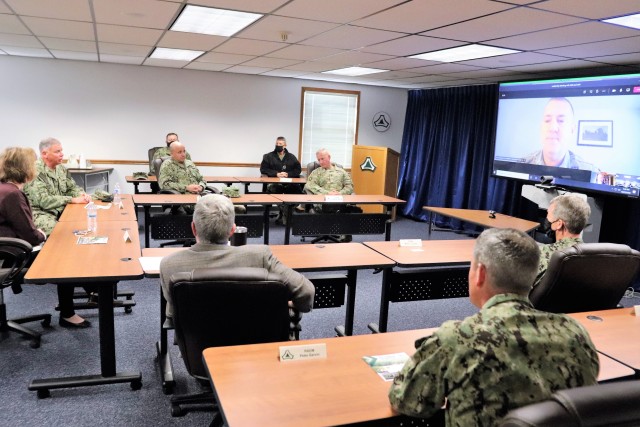 Assistant Secretary of the Navy (Manpower and Reserve Affairs) Catherine Kessmeier and Vice Adm. John Nowell, Jr., Chief of Naval Personnel (CNP), participate in a socially distanced meeting with Fort McCoy Deputy to the Garrison Commander Brad Stewart and Command Sgt. Maj. Paul Mantha, garrison command sergeant major, on Oct. 27, 2020, at the garrison headquarters building at Fort McCoy, Wis. Garrison Commander Col. Michael D. Poss dialed in virtually from a temporary duty location. The Navy leadership team visited Fort McCoy to meet with Navy cadre personnel who are working with new recruits at Fort McCoy before they attend boot camp at Recruit Training Command in Great Lakes, Ill. They stopped by to thank Fort McCoy staff for their continued support of this unique and critical Navy mission. Joining the assistant secretary and the CNP were Rear Adm. Peter Garvin, Commander of Naval Education and Training Command, Rear Adm. Jamie Sands, commander of Naval Service Training Command, and Master Chief Petty Offi